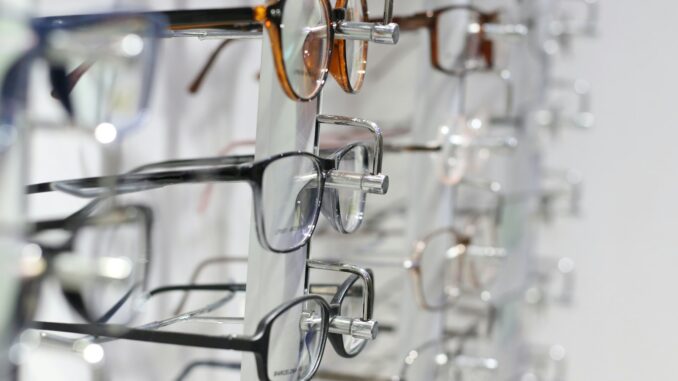 silver framed eyeglasses on clear glass